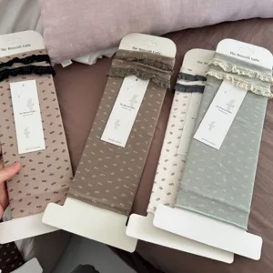 Autumn winter women stirrup socks with cute lace trim and floral pattern, neatly packaged.