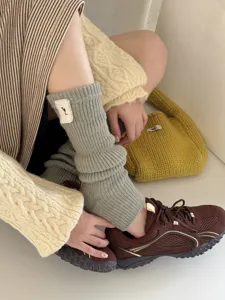 Detailed view of thick knit wool slouchy leg warmers, soft texture for autumn and winter wear.