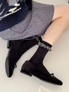 Chic women's mid-tube socks with ruffled floral cuffs detail, soft black cotton daily wear.