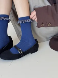 Blue ribbed mid-calf socks for women featuring cute floral ruffled cuffs, casual autumn wear.