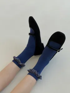 Detail view of stylish Korean style women mid-tube socks featuring cute ruffles for autumn.