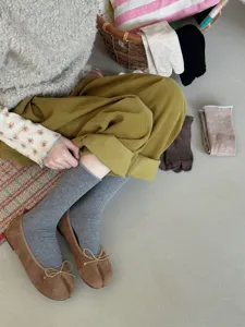 Detail shot of women split toe mid tube socks paired with flat shoes for daily casual wear.