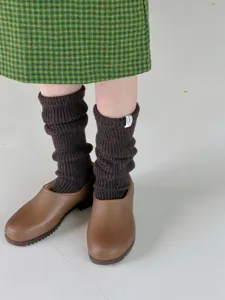 Cozy merino wool slouch socks in dark brown, thick knit winter warm leg warmers detail shot.