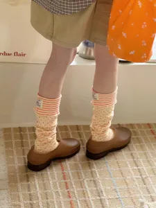 Close-up detail of Korean style layered contrast striped and polka dot socks for women.