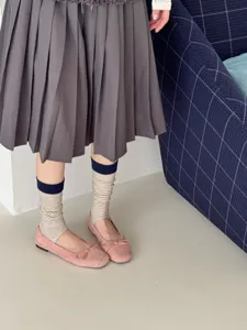 Detailed shot of stylish striped stirrup socks for women, breathable and cozy daily wear.