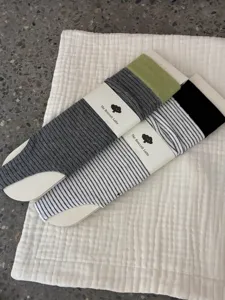 Close-up detail of stylish stirrup socks with striped patterns and neat packaging card.