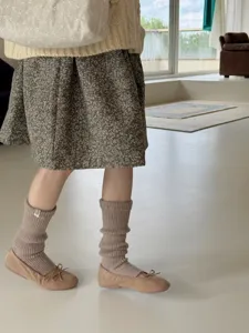 Detailed view of women's warm merino wool slouch socks in neutral beige, cozy knit ribbed texture.