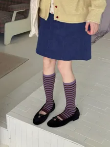 Detail view of retro contrast striped mid-calf socks for women, fashionable autumn and winter wear.