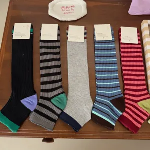Retro color block striped long cotton socks for women, stylish vintage crew hosiery.