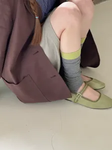 Detail shot of women's striped stirrup socks, autumn slouchy socks with color block design.