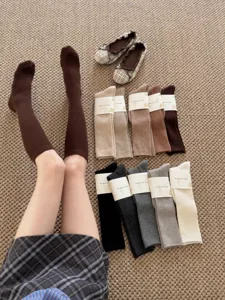 Detailed shot of solid color ribbed knee-high wool socks in various daily autumn colors.