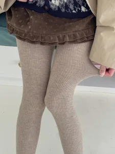 Close-up detail of women's ribbed thermal wool tights showing excellent stretch and texture.