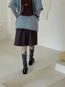 Detailed back view of Korean vintage style polka dot striped stirrup socks worn with outfit.