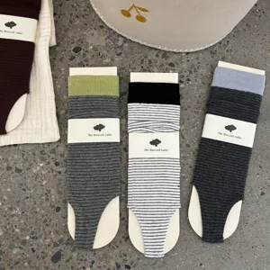 Striped stirrup socks for women, fashionable cozy knit hosiery with comfortable packaging design.