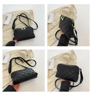 Black quilted leather shoulder bag detail showing zipper and strap, elegant design.