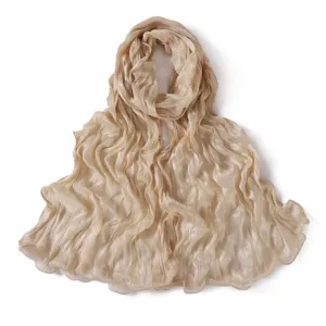 Solid beige crinkled sheer long scarf with lettuce edge, lightweight shiny hijab wrap.