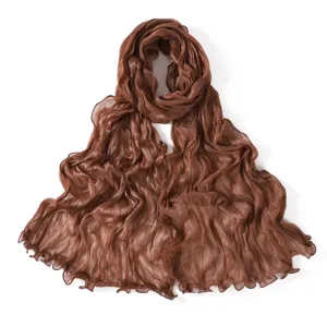 Detailed view of the brown pleated sheer scarf with lettuce edge, soft and breathable.
