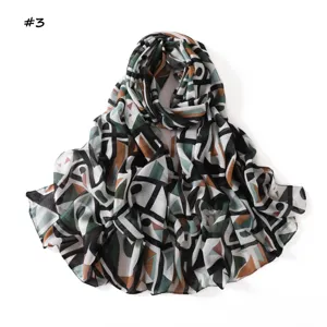 Close-up detail of the geometric color block print scarf, showing soft fabric texture.