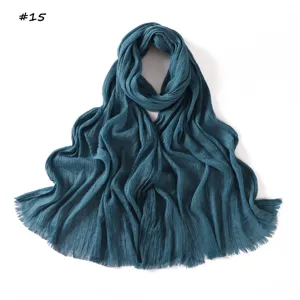 Detailed view of dark blue pleated fringed women scarf, elegant texture and soft fabric.