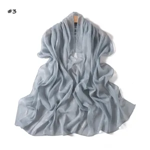 Detail view of light grey shimmering chiffon long scarf, elegant pleated texture, breathable design.