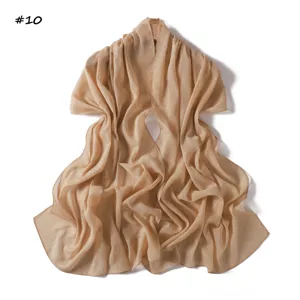 Detail view of the shimmering silver silk chiffon scarf with fine pleats in light khaki.