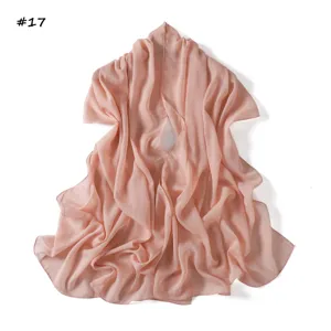 Pink metallic chiffon scarf detail, lightweight breathable sheer shawl texture close-up.