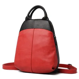 Red and black leather backpack detail view, featuring dual shoulder straps and top handle.