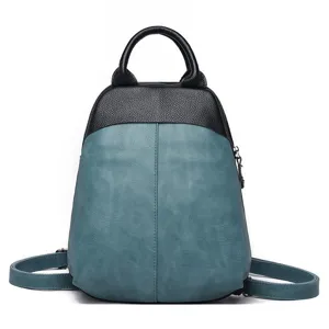 Close-up detail of the stylish color-block leather backpack showing fine texture and zipper.