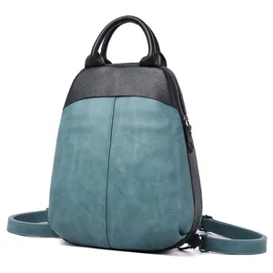 Close-up detail of stylish color-block genuine leather women rucksack with shell shape.