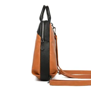 Detailed side view of the women's color-block leather backpack showing dual texture and zippers.