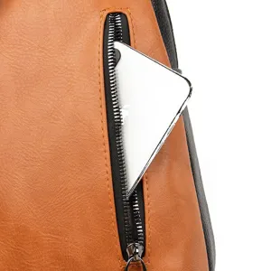Close-up detail of the leather backpack zippered pocket showing smooth metal zipper.