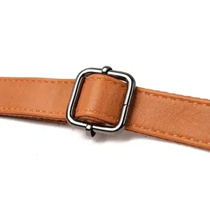 Brown leather backpack adjustable strap detail with metal buckle for classic daily use