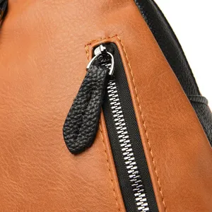 Detailed view of color-block leather backpack zipper and texture, exquisite stitching.