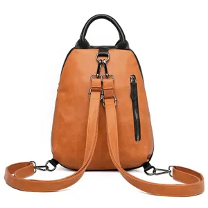 Detailed view of the contrast color leather backpack showcasing its straps and zippers.