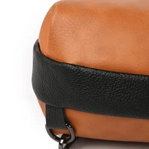 Close-up detail view of color-block leather backpack strap and textured material design.
