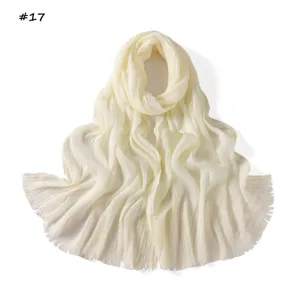 Detailed view of the elegant pleated solid color women's fringe scarf in cream white.
