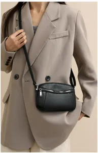 Black genuine leather crossbody bag for women, mini shoulder bag with double zippers detail.