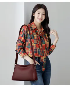 Women's leather shoulder bag detail shot showcasing fine texture and premium hardware design.