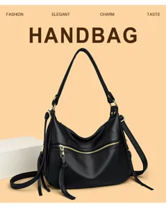 Detail view of the black PU leather handbag with metallic zipper and tassel charm.