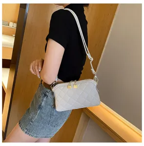 Detail view of the stylish quilted leather crossbody shoulder bag with delicate metal zippers.