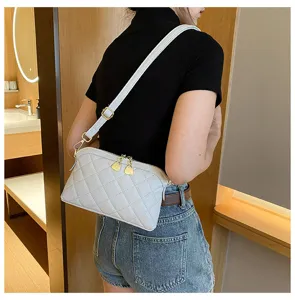 Detail view of stylish quilted leather shoulder crossbody bag in light grey, elegant wear style.