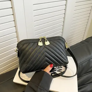 Black leather chevron crossbody bag for women, stylish shoulder bag with gold hardware.