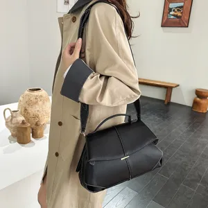 Vue de détail du sac bandoulière Boston noir en cuir pour femme avec coutures blanches.