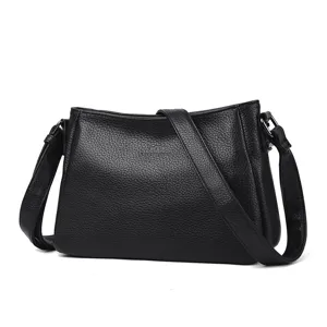 Detail view of black leather shoulder bag, premium texture and durable hardware.