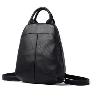 Detailed view of a stylish black leather backpack with top handle and adjustable straps.