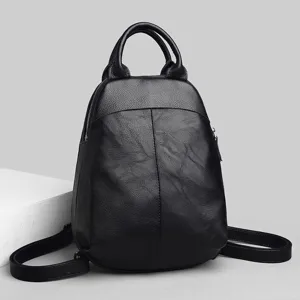 Detailed view of the stylish black leather women backpack, showcasing fine texture and dual straps.