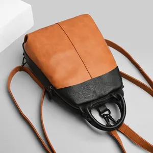 Detail view of a stylish two-tone leather women backpack featuring brown and black design.