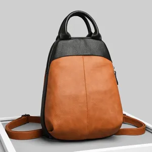 Detailed view of the stylish two-tone leather backpack featuring a top handle and straps.