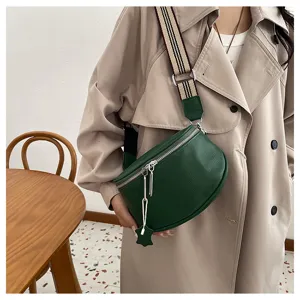 Genuine leather saddle bag for women, stylish green crossbody shoulder bag with wide strap.