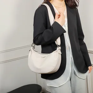 Detailed view of women white leather dumpling shoulder bag, casual crossbody bag for daily use.